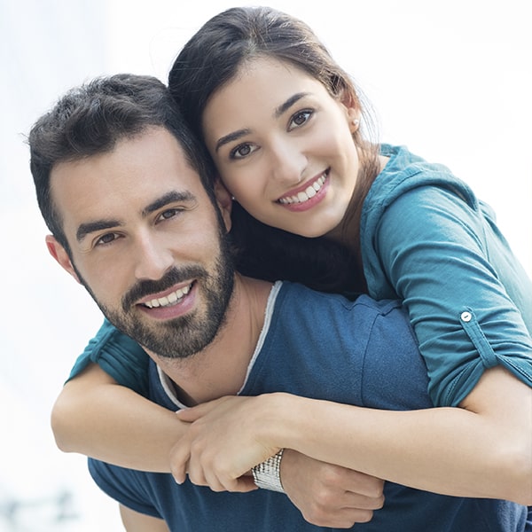 A couple smiling and hugging each other